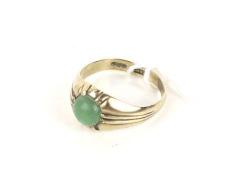 A far eastern small jadeite round cabochon single stone gypsy ring, stamped '14K', size M, 3.4g gross