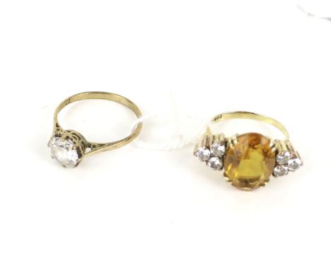 Two 9ct gold and gem set dress rings. Comprising; a cubic zirconia single stone ring, the hallmarks obscured, size O, 1.8g gr