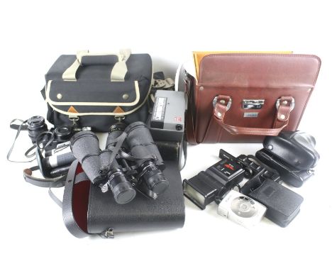 An assortment of vintage cameras and optical items. Including a pair of Mark Scheffel binoculars, Kenko 58mm lens, magazines,