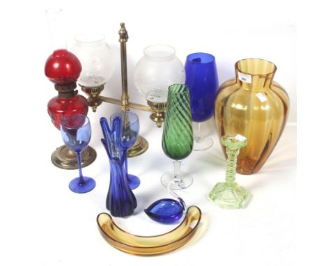 An assortment of glassware. Including a red glass oil lamp, a uranium glass candlestick, etc. Max H43cm
