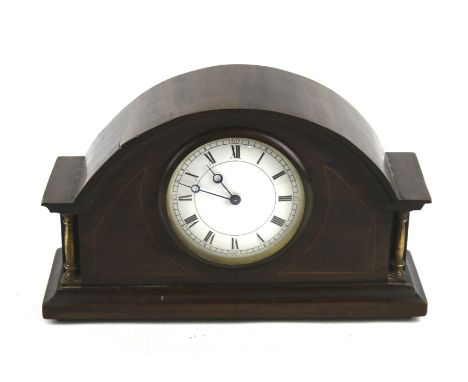 A Victorian mantel clock. The white enamel dial with Roman numerals, within an inlaid mahogany case with brass columns, H15cm