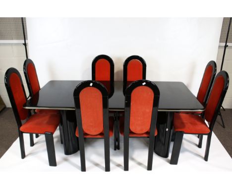 A vintage dining table and eight chairs. Black lacquer with red upholstery, the table of rectangular form on four oval suppor