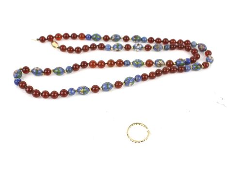 A vintage gold and paste eternity ring and a carnelian and coloured glass bead necklace. The worn-paste eternity ring stamped