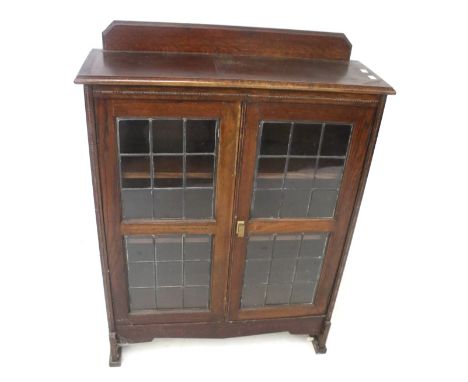 A vintage oak glazed display cabinet. With two leaded glass doors. L76cm x D25cm x H103cm