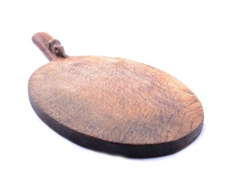 Robert Mouseman Thompson of Kilburn, oak cheeseboard, oval, the handle carved with a mouse, 38cm.