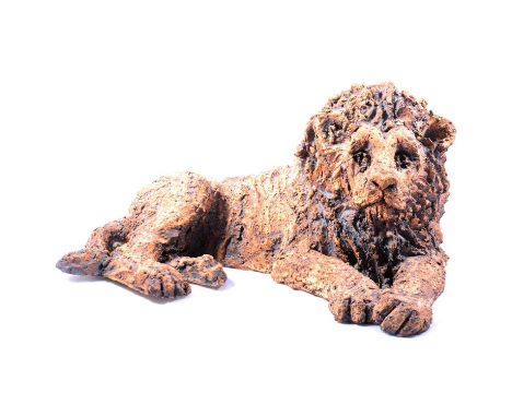 Studio ceramic stoneware lion, late 20th century, modelled reclining, head raised, appears unsigned, 42cm wide, 20cm high.