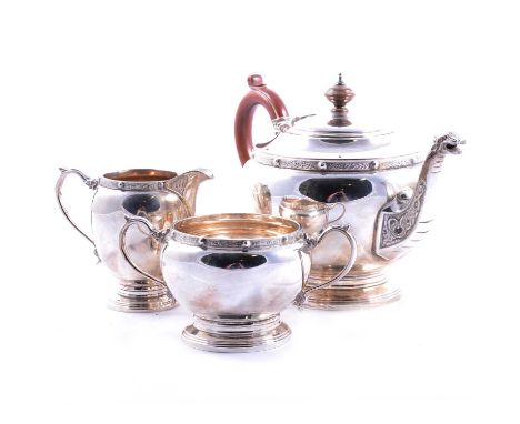 A silver three-piece teaset, Adie Bros Ltd, Birmingham 1963, rounded form with Celtic pattern decoration, teapot (18cm) with 