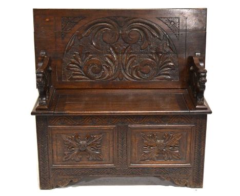 Victorian carved oak monk's bench, hinged back on lion armrests, box base, width 106cm, depth 51cm, height 101cm.
