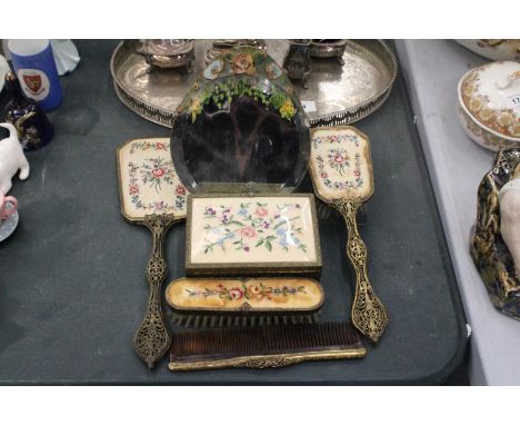 A VINTAGE DRESSING TABLE SET WITH PETIT-POINT DECORATION TO INCLUDE A TABLE MIRROR, HAND MIRROR, BRUSHES, A COMB AND A TRINKE