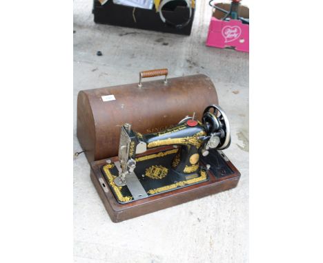 A VINTAGE SINGER SEWING MACHINE WITH WOODEN CARRY CASE AND KEY 