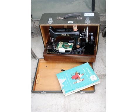 A MANUAL VINTAGE SINGER SEWING MACHINE WITH ELECTRIC LIGHT AND CARRY CASE 