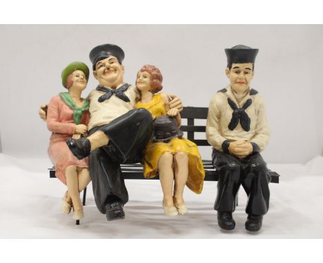 A VINTAGE MODEL OF LAURELAND HARDY ON A BENCH 