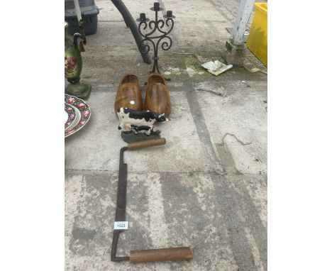 AN ASSORTMENT OF ITEMS TO INCLUDE WOODEN CLOGGS, A CAST IRON DOOR STOP AND A CANDLESTICK ETC 