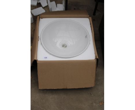 AN AS NEW AND BOXED WHITE CERAMIC WASH BASIN 