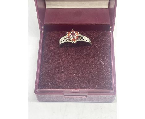 A 925 SILVER RING WITH RED STONES SIZE O/P IN A PRESENTATION BOX 