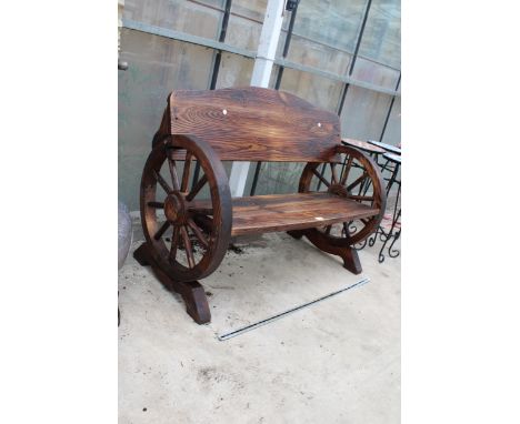 A VINTAGE STYLE WOODEN GARDEN BENCH WITH CART WHEEL ENDS 