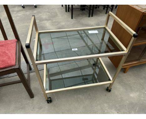 A METALWARE 2-TIER TROLLEY WITH SMOKED GLASS TOP AND SHELF 