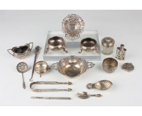 A small group of silver, including a pierced two-handled dish, Birmingham 1914, four salts, a pair of sugar tongs and a caddy