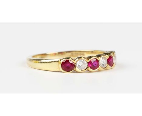 An 18ct gold, ruby and diamond ring, mounted with four circular cut rubies alternating with three circular cut diamonds, Lond