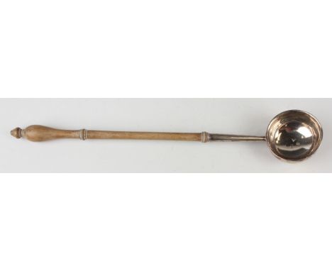 A George I silver punch ladle, the circular bowl with outswept rim and turned wood handle, London 1726, length 37cm.Buyer’s P