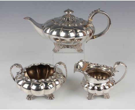 A William IV Sheffield plate three-piece tea set of lobed squat circular form with foliate capped scroll handles, comprising 