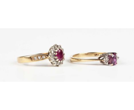 A 9ct gold, ruby and diamond oval cluster ring, claw set with the oval cut ruby within a surround of circular cut diamonds be