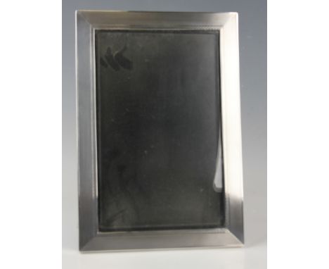 A George V silver rectangular engine turned photograph frame with Bakelite easel back, London 1932 by British Metallising Co 