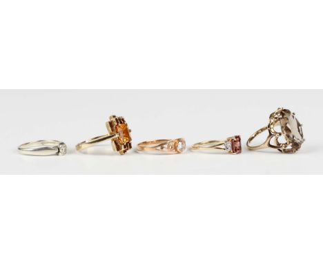 A 9ct white gold and diamond single stone ring, a 9ct gold ring, claw set with an oval cut smoky quartz, another 9ct gold rin