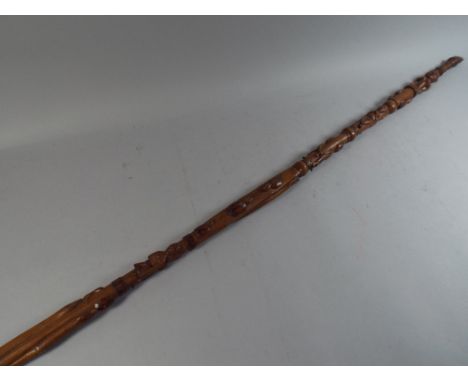 A Carved African Walking Stick Decorated with Figures and Snakes and with Hand Finial. 107cm