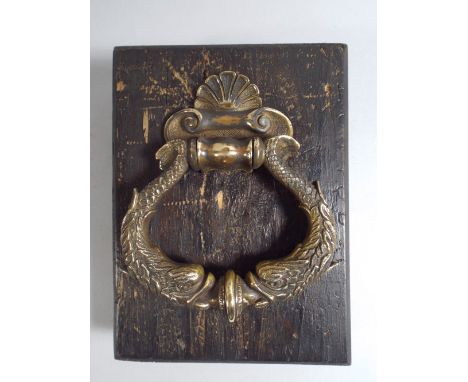 A 19th Century Regency Brass Door Knocker Modelled as Two Dolphins.13x15cm