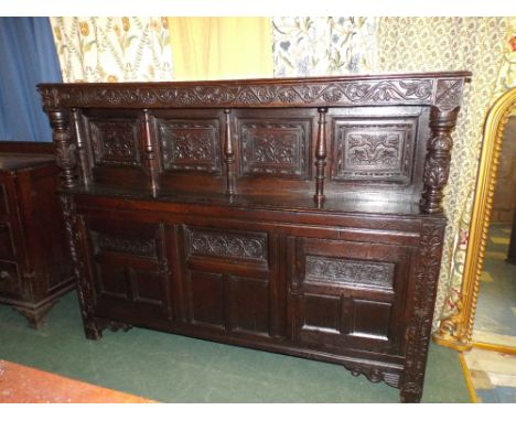 An Early Carved Oak Deuddarn with Pegged Joints. Four Panels and Carved Doors to Top Cupboard and Three Carved and Panelled D