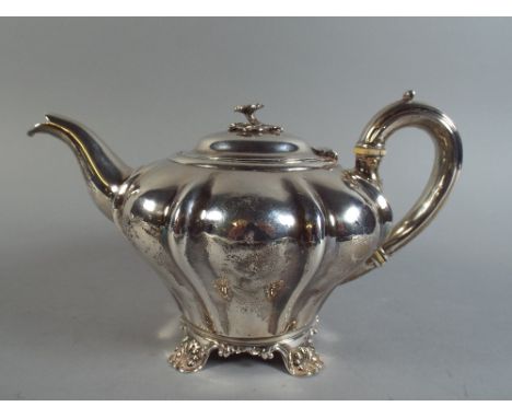 A Victorian Silver Teapot with Lobed Body and Flower Finial to Hinged Lid. London 1839