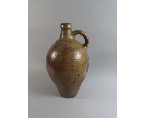 An 18th Century Salt Glazed Pottery Bellarmine Type Bottle of Typical Form with a Ring Neck and a Single Handle on a Wasted B