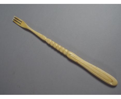 A 19th Century Ivory Three Pronged Fork with a Carved Handle
