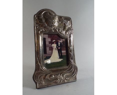 A Silver Easel Photo Frame in the Art Nouveau Style. London 1987 Decorated with Maiden and Moon in Relief. 26cm High