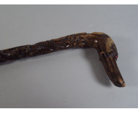 A Carved Walking Stick with Greyhound Handle Having Red Glass Eyes. 89cm