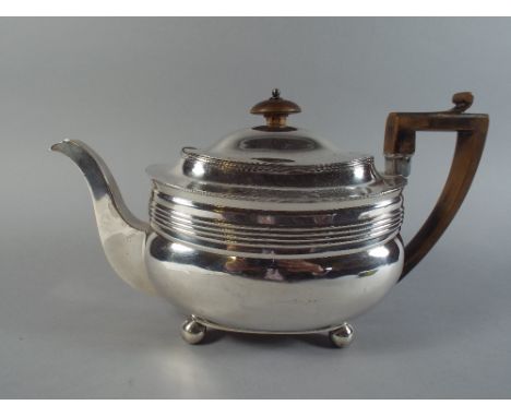 A Georgian Silver Tea Pot with Ribbed Decoration, Wooden Finial and Handle on Four Ball Feet. 28x16cm Tall 575g.