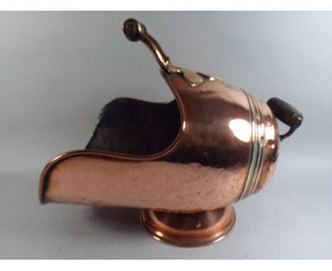 A Late 19th Century Helmet SHaped Coal Scuttle with Turned Wooden Handles