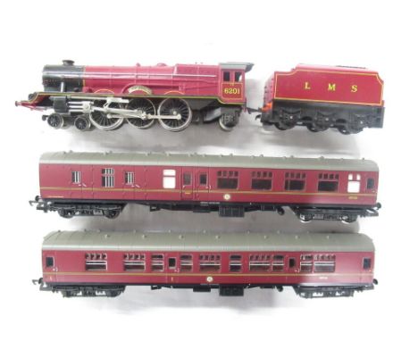 00-gauge Queen Elizabeth 6201 engine with LMS coal tender in burgundy livery and 2 Harry Potter passenger cars 