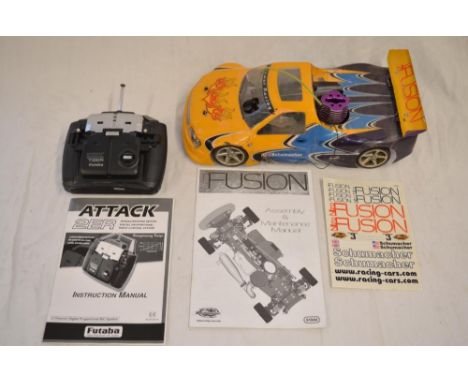 A Fusion Schumacher 1/10 scale nitro 4WD radio control car with instruction manual and a Futaba Attack 2ER 2 channel handheld