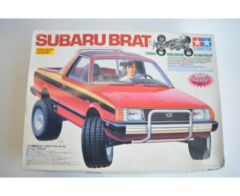 Stock Tamiya Suburu Brat, 2WD 1/10th scale radio control car. Model has been started and chassis part built. Includes ESC and