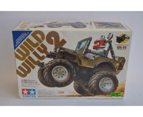 Tamiya 1/10 scale radio control Wild Willy 2, chassis built up, bodywork not started.Runs but steering servo not working, may