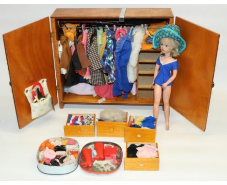 Vintage late 1960s Sindy doll with a large collection of outfits and accessories in a scratch-built wooden wardrobe, and a St