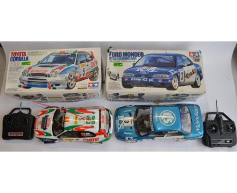 2 Tamiya 1/10 radio control cars with transmitters, both A/F: Ford Mondeo BTCC Touring car. Front right suspension damaged, t