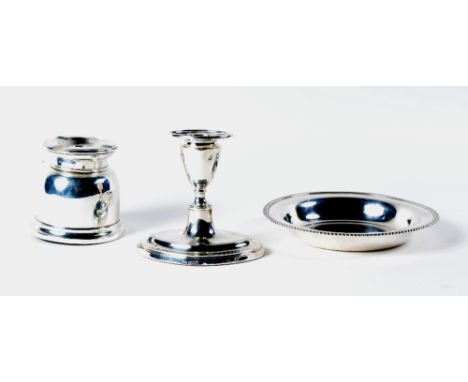 A Georgian style silver squab candlestick on lozenge-shaped base, together with a circular silver dish with gadroon border, 2