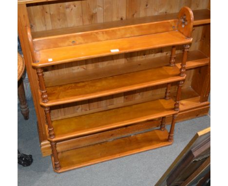 A 20th Century four tier walnut set of shelves with turned supports between each shelf, 92cm high, 79cm wide, together with a
