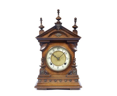 A German mantel clock with Gothic enamel chapter ring, the twin train movement with coiled gong strike within an architectura