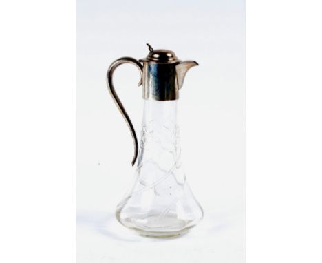 A cut glass decanter of tapering cylindrical form with plain silver mounted neck, lid and handle, Birmingham 1907