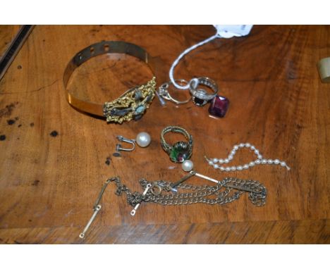 A small collection of miscellaneous jewellery including two gold rings, a stylised bangle, further rings etc