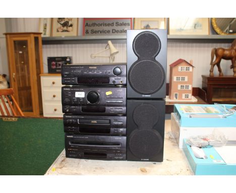 A Technic stack comprising stereo tuner amplifier, CD player, Stereo double cassette deck and a Dolby surround Stereo sound p